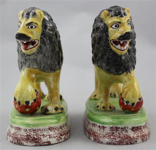 A pair of British pottery figures of lions, c.1820, 16cm., restorations